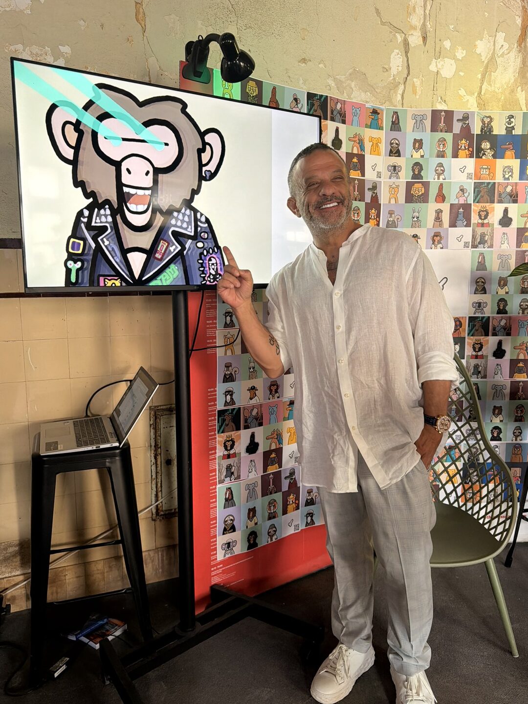 Adam Weitsman at NFT Summit Lisbon — pointing at a Bored Ape on screen