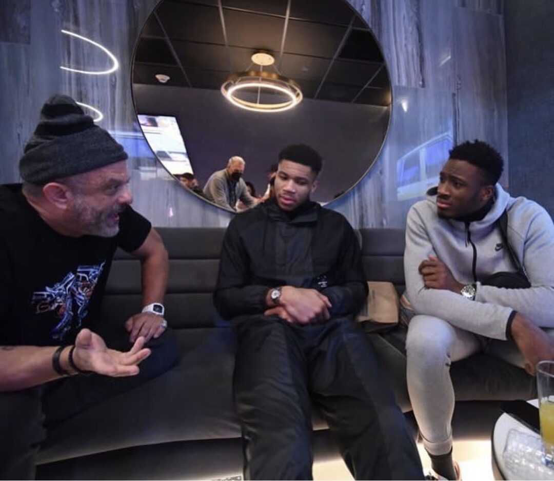 Adam Weitsman in beanie with Giannis and Thanasis Antetokounmpo at Cuse Dome